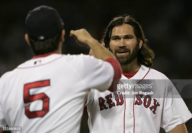 Boston Red Sox batter Johnny Damon, right, is congratulated by teammate Nomar Garciaparra after Damon collected a hit against the Texas Rangers...