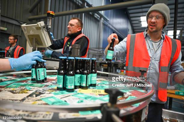 BrewDog founder James Watt packs hand sanitizer being produced at the plant on April 03, 2020 in Ellon, Scotland. Scotland based brewery BrewDog have...