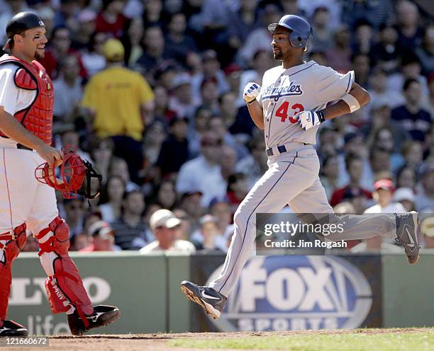Boston Red Sox catcher Doug Mirabelli, left, watches the actions as Los Angeles Dodgers base runner Juan Encarnacion scores at Fenway Park in Boston,...