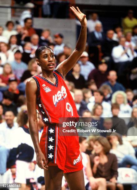 Team USA's Lisa Leslie raises her hand to acknowledge a foul she committed during an exhibition game against the UConn Huskies women's basketball...