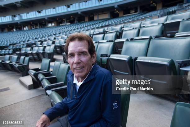 Portrait of American former baseball player, All-Star pitcher, and White Sox Broadcaster Ed Farmer as he sits in the stands at Comiskey Park,...