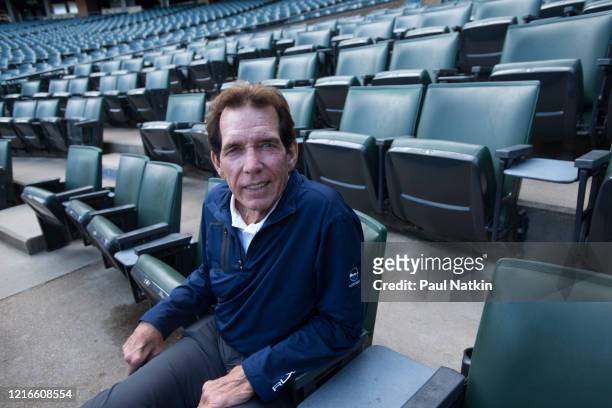Portrait of American former baseball player, All-Star pitcher, and White Sox Broadcaster Ed Farmer as he sits in the stands at Comiskey Park,...
