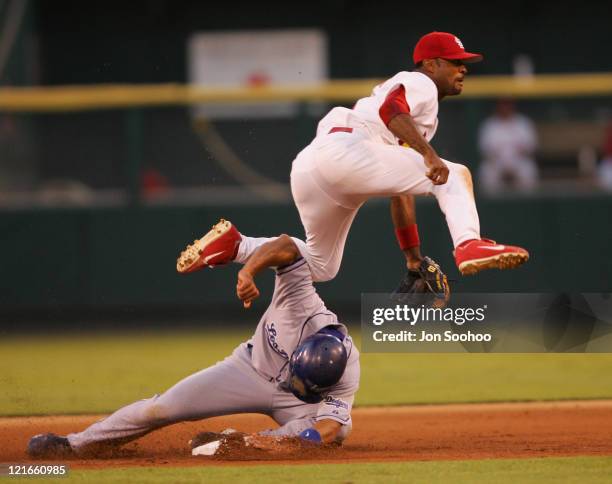 St. Louis Cardinals Tony Womack,in white, throws the ball to first base as Los Angeles Dodgers Alex Cora tries to disrupt the play on the 5th inning...