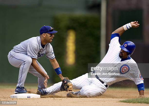 Chicago Cubs Derrek Lee, right, slides safely to second base as Los Angeles Dodgers Alex Cora drops the ball in the fifth inning Friday, August 13,...