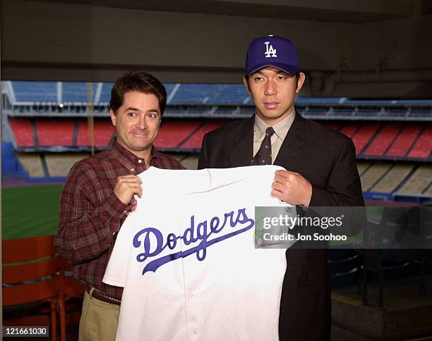 Los Angeles Dodgers General Manager Dan Evans with newest acquisition Hideo Nomo during press conference at Dodger Stadium. Nomo signed a 2 - year...