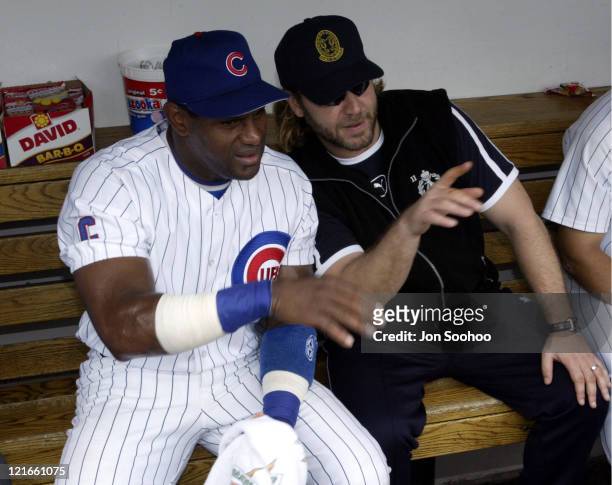 Cubs' Sammy Sosa and actor Russell Crowe talk during pregame at Wrigley Field.