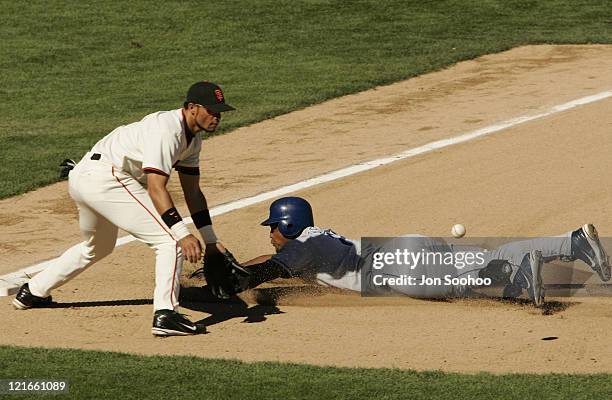 Los Angeles Dodgers Adrian Beltre dives safely into third base as San Francisco Giants Pedro Feliz waits for ball Sunday, September 26, 2004 at SBC...