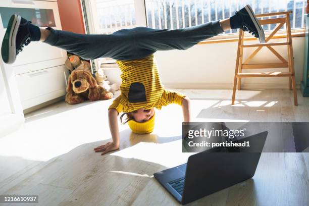 家で休憩を踊る小さな男の子。ヘッドスタンド。ホームプレジャー。eラーニング - headstand ストックフォトと画像