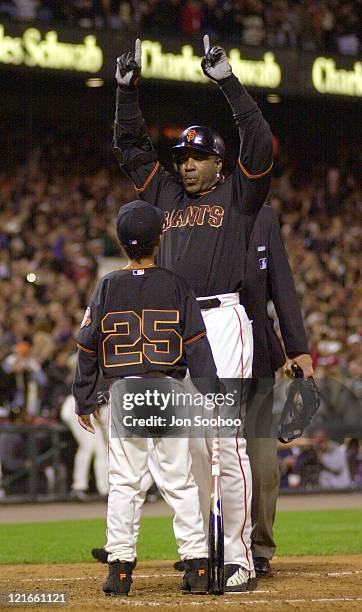 Barry Bonds is greeted at Home Plate by his son after hitting his 71st home run of the season to Break Mark McGwire's single season record