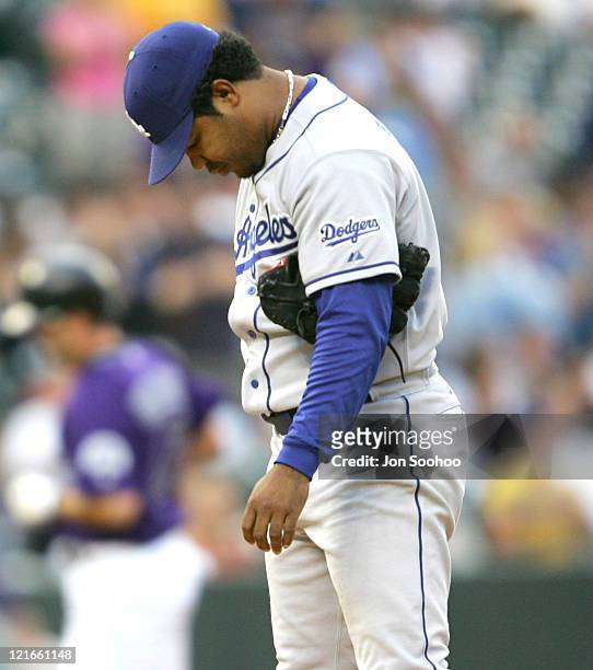 Los Angeles Dodgers starting pitcher Odalis Perez grimaces after giving up first inning home run to Colorado Rockies Todd Helton at Coors Field in...