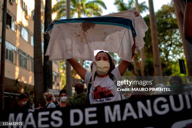 Bruna da Silva, mother of Marcos Vinicius killed in 2018 by a police officer at the Complexo da Mare favela, holds the school T-shirt he was wearing...