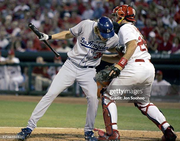 Los Angeles Dodgers Jeff Weaver leaps towards St. Louis Cardinals catcher Mike Metheny avoinding inside pitch Thursday, October 7, 2004 at Busch...