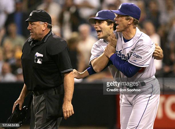 Los Angeles Dodgers manager Jim Tracy [R] holds back Dodger Robin Ventura from going after umpire Ed Montague during game vs San Diego Padres,...