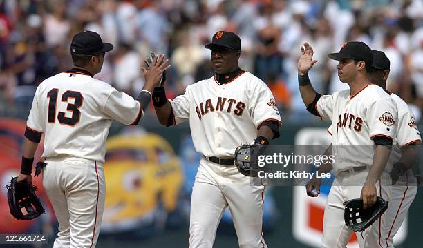Barry Bonds exchanges high five with Edgardo Alfonzo after the San Francisco Giants' 3-1 victory over the New York Mets at SBC Park in San Francisco,...