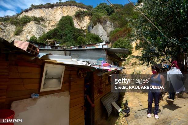 Yeimy Martinez stands outside her house in Ciudad Bolivar neighbourhood, southern Bogota, on May 26, 2020. - In the midst of the new coronavirus...