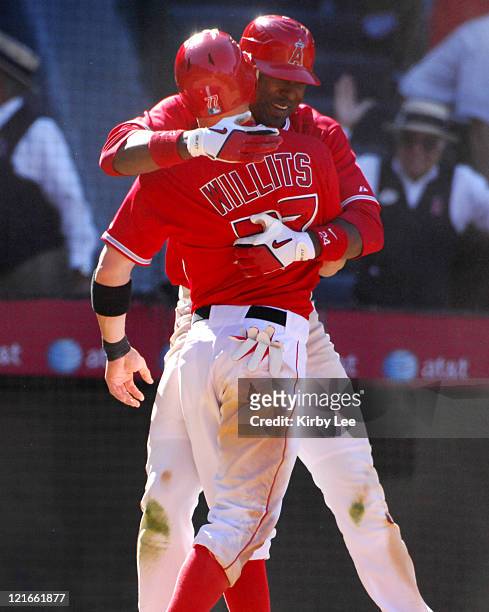 Reggie Willits is embraced by Gary Matthews Jr. In celebration after scoring the winning run in the 10th inning of 9-8 victory over the Detroit...