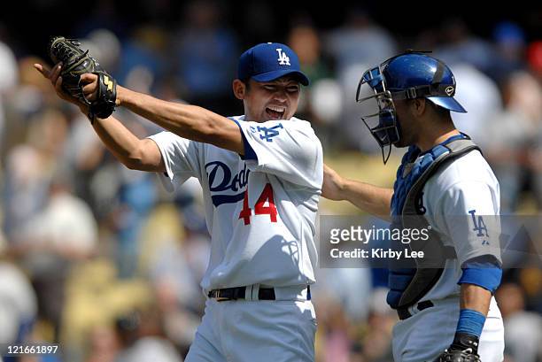Los Angeles Dodgers Japanese reliever Takashi Saito is congratulated by catcher Russell Martin after picking up his eighth save during 2-1 victory...