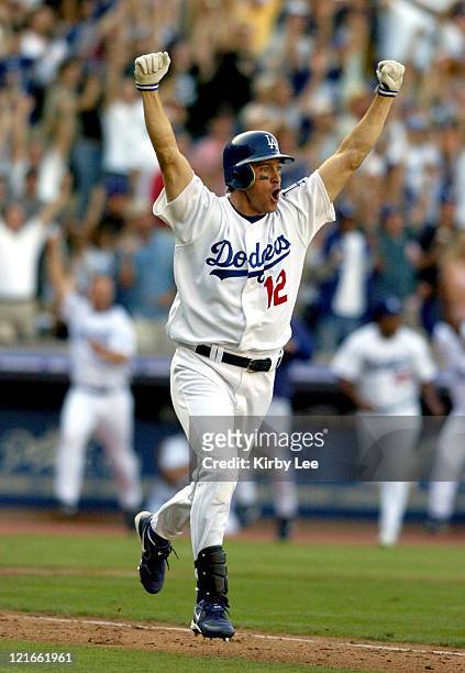 Steve Finley of the Los Angeles Dodgers celebrates after hitting a grand-slam home run in the bottom of the ninth inning in 7-3 victory over the San...