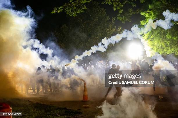 Tear gas rises above as protesters face off with police during a demonstration outside the White House over the death of George Floyd at the hands of...