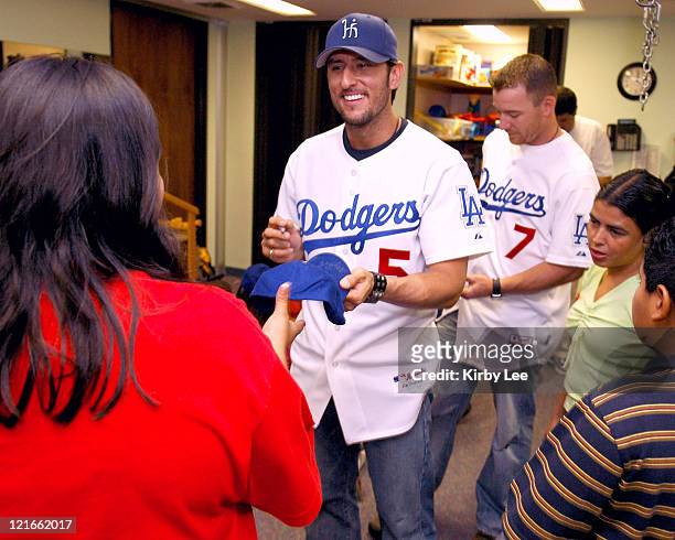 Nomar Garciaparra and J.D. Drew of the Los Angeles Dodgers signs autographs during a visit to the White Memorial Medical Center Pediatric Unit in Los...