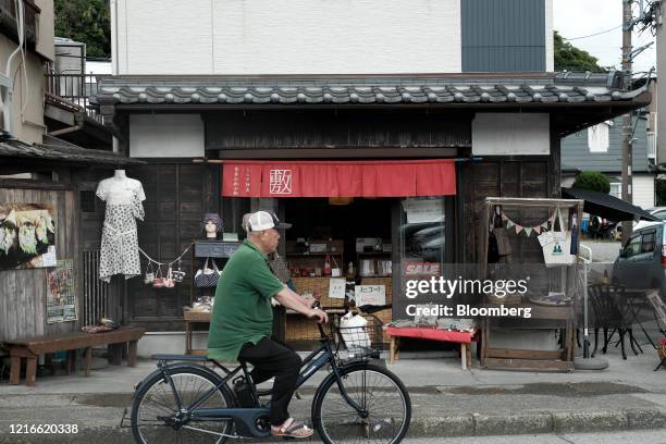 Cyclist rides past a gift shop along Komachi Street in Kamakura, Kanagawa Prefecture, Japan, on Sunday, May 31, 2020. Japan ended the state of...