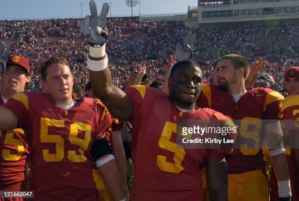 Running back Reggie Bush and linebacker Collin Ashton celebrate 23-17 victory over Cal in Pac-10 Conference football game at the Los Angeles Memorial...