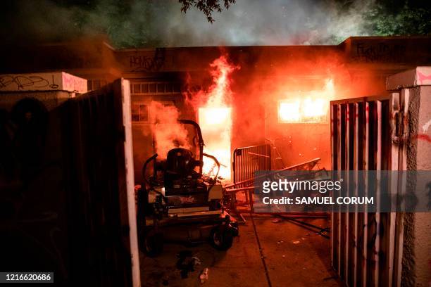 Maintenance building in Lafayette Park across the street from the White House burns as people protest the death of George Floyd at the hands of...