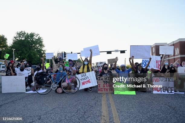 Protesters demonstrate while sitting down outside the Ferguson Police Department on May 31, 2020 in Ferguson, Missouri. Major cities nationwide saw...