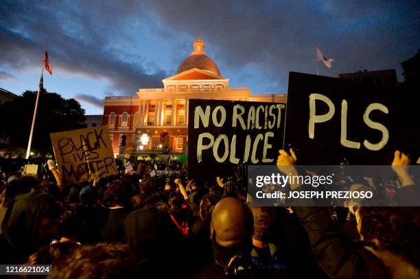 Protesters gather outside the Massachusetts State House during a demonstration over the death of George Floyd, an unarmed black man who died in...