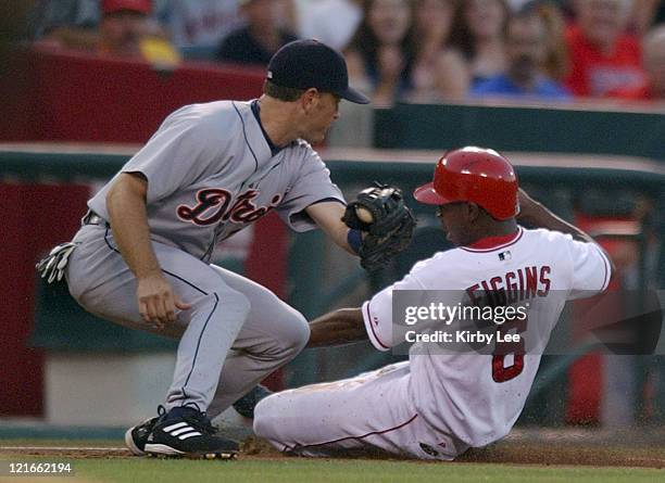 Chone Figgins of the Anaheim Angels slides into third base beneath tag of Shane Halter of the Detroit Tigers. The Angels defeated the Tigers, 3-1