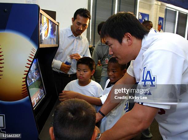 Hee-Seop Choi of the Los Angeles Dodgers plays video games with children at the L.A. Boys & Girls Club in Los Angeles, Calif. Wednesday, Aug. 24,...