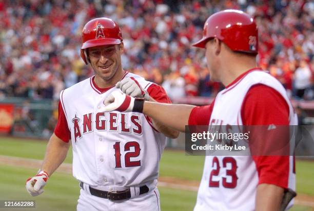 Steve Finley of the Los Angeles Angels of Anaheim is congraulated by Dallas McPherson after hitting a seventh-inning home in 1-0 victory over the...