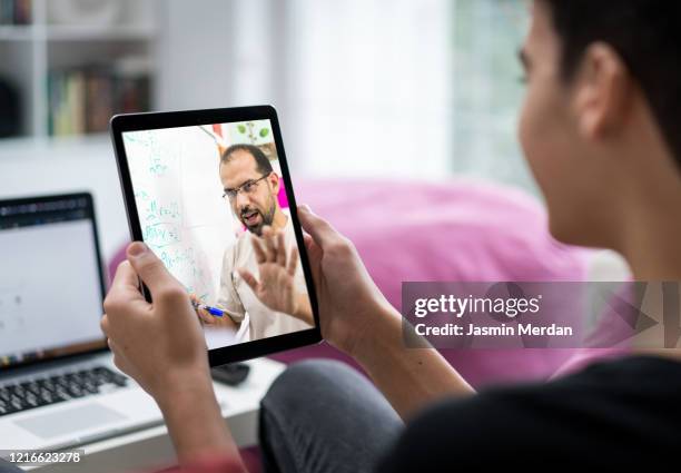 e-learning using tablet between male student and teacher - e learning teacher stock pictures, royalty-free photos & images