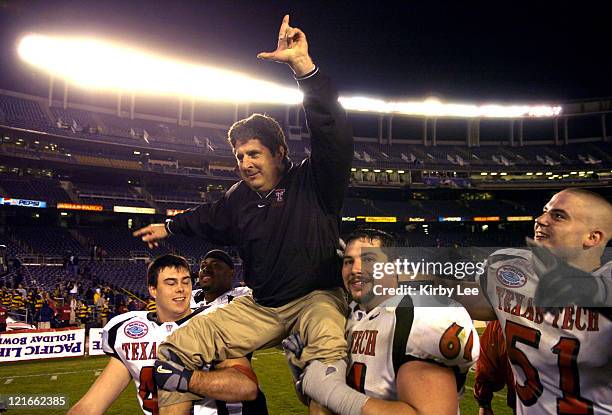 Celebratory Texas Tech coach Mike Leach is hoisted by Mike Smith and Cody Campbell as Dek Bake watches after 45-31 victory over Cal in the Pacific...