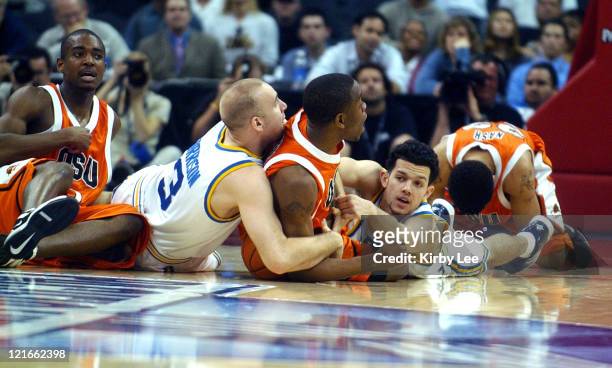 Chris Stephens of Oregon State battles for loose ball with UCLA's Brian Morrison and Jordan Farmar during 79-72 first-round victory in the Pacific...