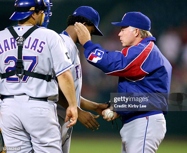 Texas Rangers manager Buck Showalter removes reliever Edison Volquez as catcher Rod Barajas watches in the sixth inning of 7-4 loss to the Los...