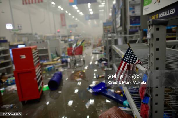 An American flag drapes across looted shelves in a hardware store during widespread unrest following the death of George Floyd on May 31, 2020 in...