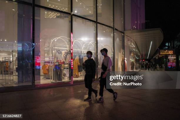 Shopping goers wear protective masks at the shopping district of Bukit Bintang in Kuala Lumpur city center Malaysia during Conditional Movement...