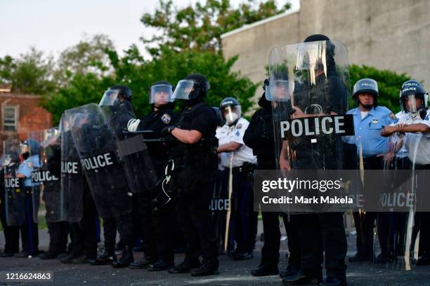 Police create a barrier in front of a damage vehicle during widespread unrest following the death of George Floyd on May 31, 2020 in Philadelphia,...