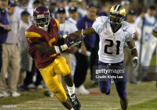 Reggie Bush of USC catches a pass in front of Washington cornerback Derrick Johnson in the fourth quarter of 38-0 victory in Pacific-10 Conference...