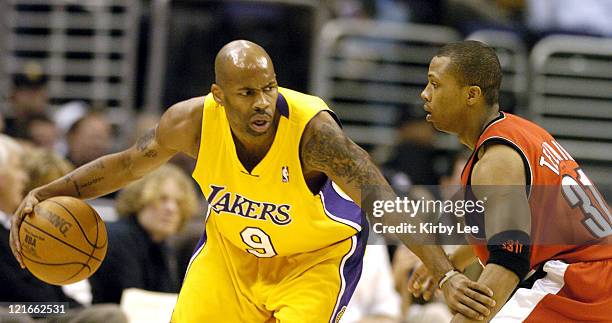 Chucky Atkins of the Los Angeles Lakers is guarded by Sebastian Telfair of the Portland Trail Blazers during the game between the Los Angeles Lakers...