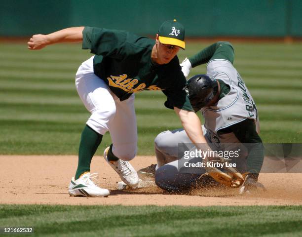 Carl Crawford of the Tampa Bay Devil Rays slides into second base beneath the tag of Mark Ellis for a stolen base during 3-2 victory at McAfee...