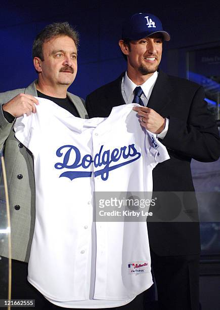 Los Angeles Dodgers general manager Ned Colletti and Nomar Garciaparra pose at press conference to announce signing of Garciaparra to a one-year...