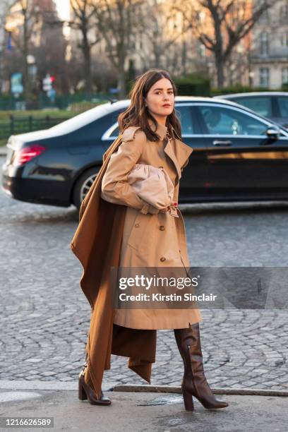 Digital influencer Paola Alberdi wears a Burberry trench coat, Bottega Veneta bag and Tabitha Simmons boots on February 26, 2020 in Paris, France.