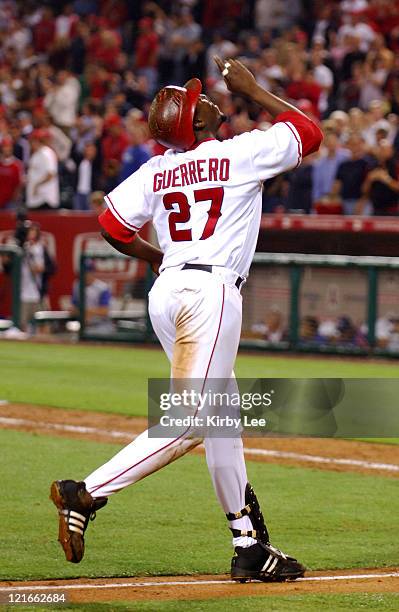 Vladimir Guerrero of the Los Angeles Angels of Anaheim points skyward in celebration after hitting a solo home run in the eighth inning of 8-3...