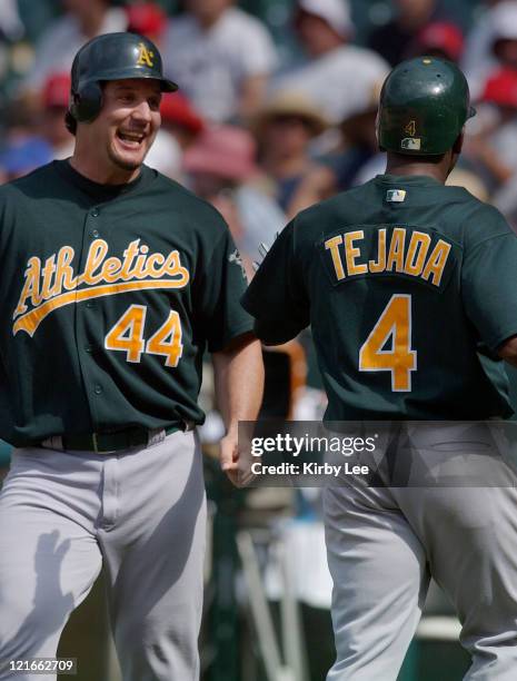 Erubiel Durazo of the Oakland Athletics greets Miguel Tejada after they scored in the ninth inning on a double by Eric Chavez. The Athletics defeated...