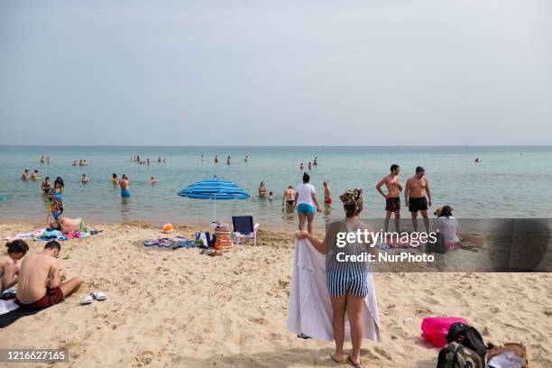 The overcrowded beach of Potamos in Epanomi during a heatwave, a beach near Thessaloniki and Halkidiki. Beach bars and organized beaches are open...