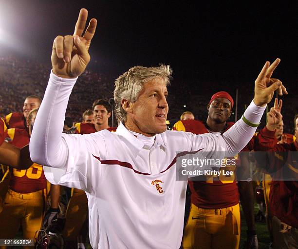 Coach Pete Carroll holds up the "Fight On" sign in celebration after 28-21 victory over Arizona State in Pacific-10 Conference game for the Trojans'...