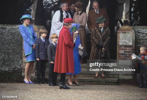 British royals Diana, Princess of Wales , wearing a blue and turquoise suit by Catherine Walker, with a matching hat, Prince William, Prince Harry,...