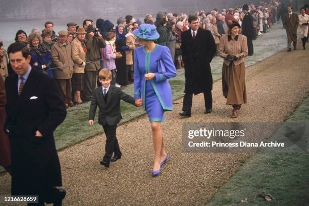 British royals Prince Charles, Prince Harry, Diana, Princess of Wales , wearing a blue and turquoise suit by Catherine Walker, with a matching hat,...